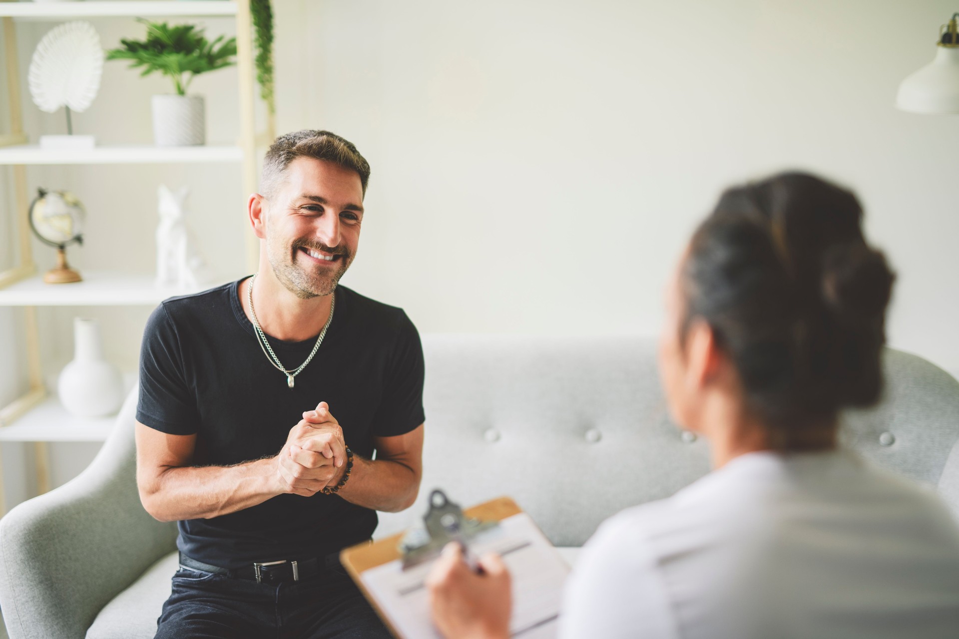 Man with psychologist theraphy social problems concept drug addiction talk to a psychological woman